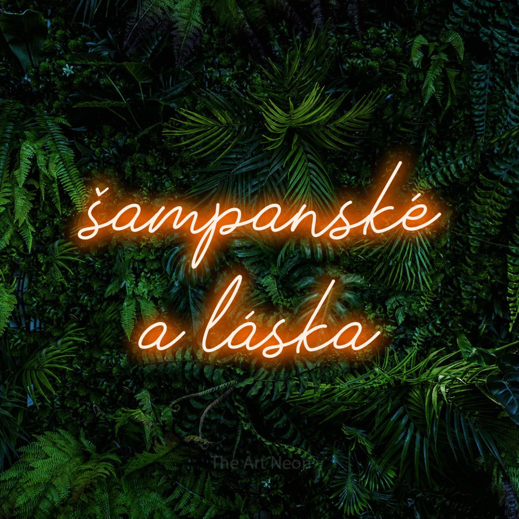 LED neon sign reading “šampanské a láska”, arranged in two lines.