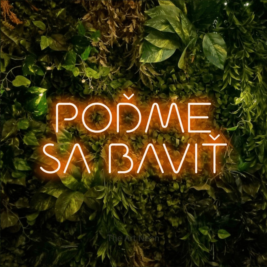LED neon sign reading “POĎME SA BAVIŤ”, arranged in two lines.