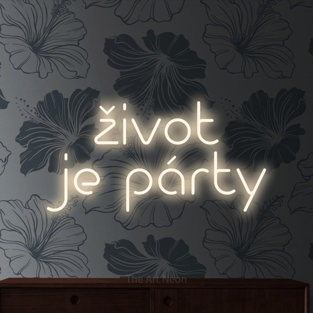 LED neon sign reading “život je párty”, arranged in two lines.
