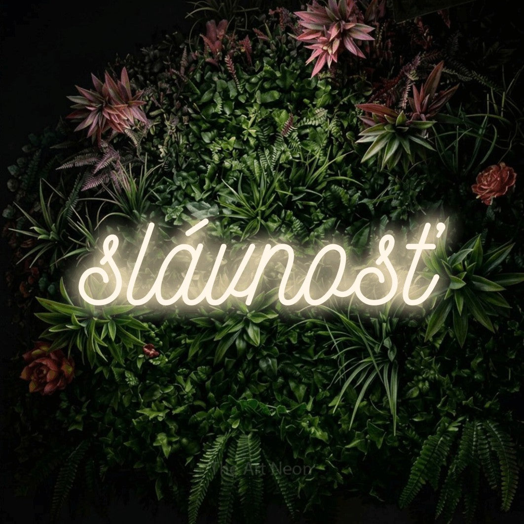 LED neon sign reading “slávnosť”, arranged in a single line.