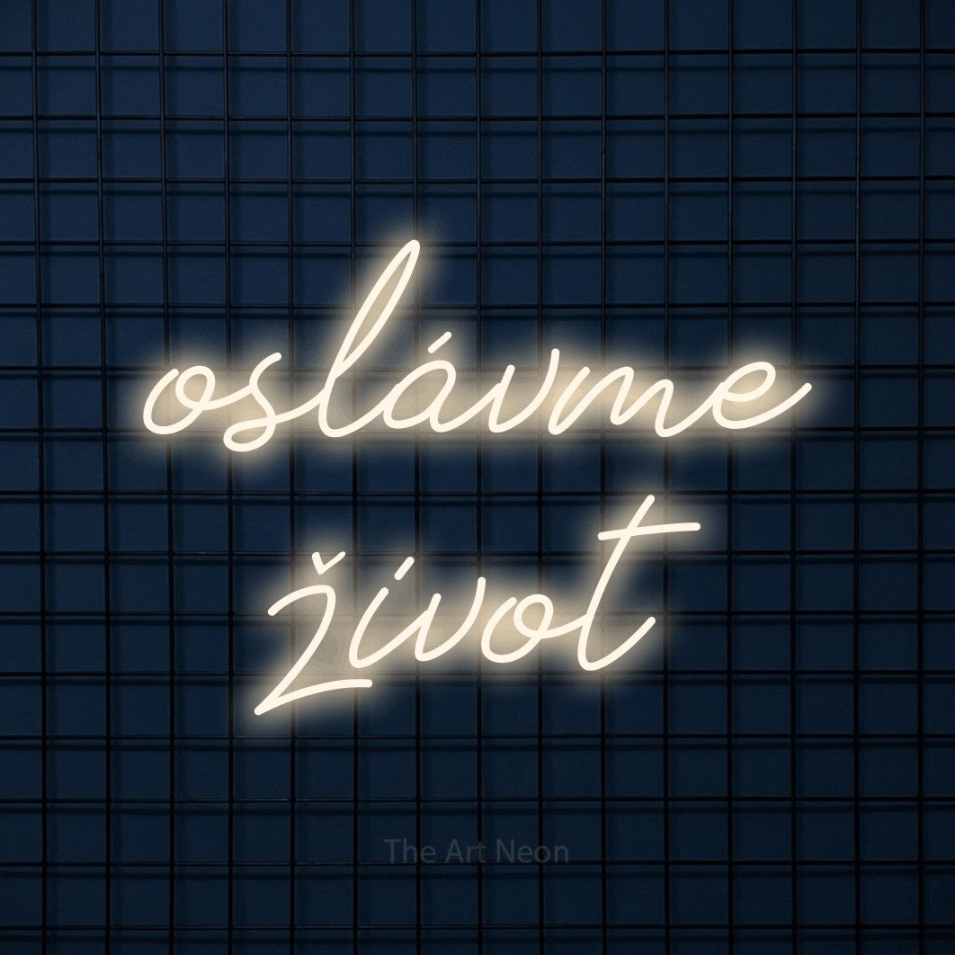 LED neon sign reading “oslávme život”, arranged in two lines.