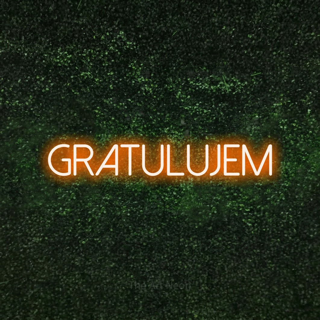 LED neon sign reading “GRATULUJEM”, arranged in a single line.