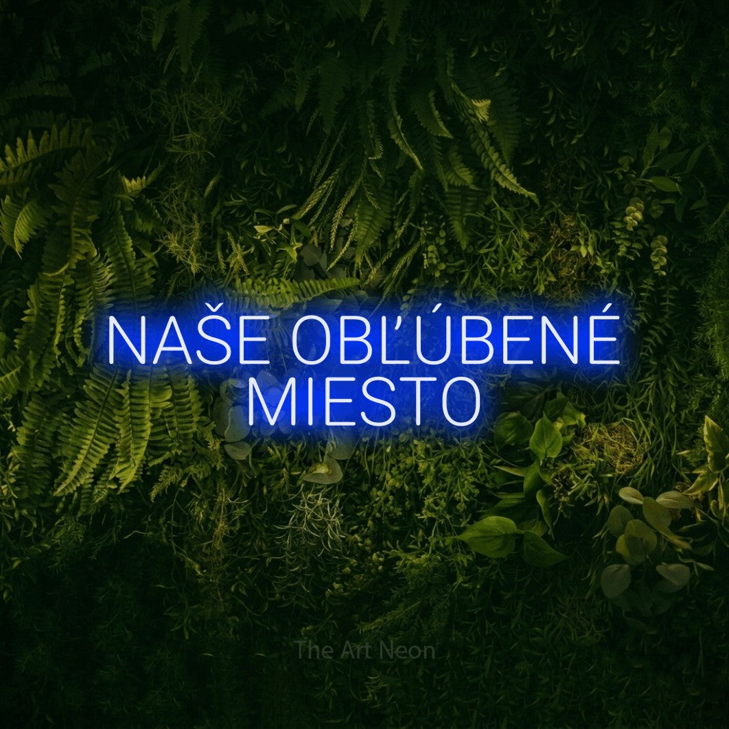 LED neon sign reading “NAŠE OBĽÚBENÉ MIESTO”, arranged in two lines.