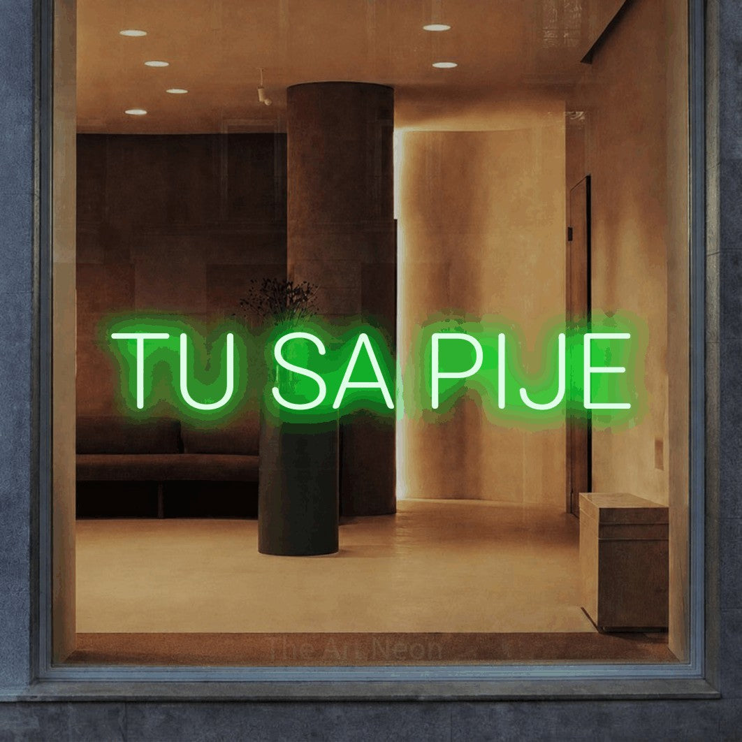 LED neon sign reading “TU SA PIJE”, arranged in a single line.