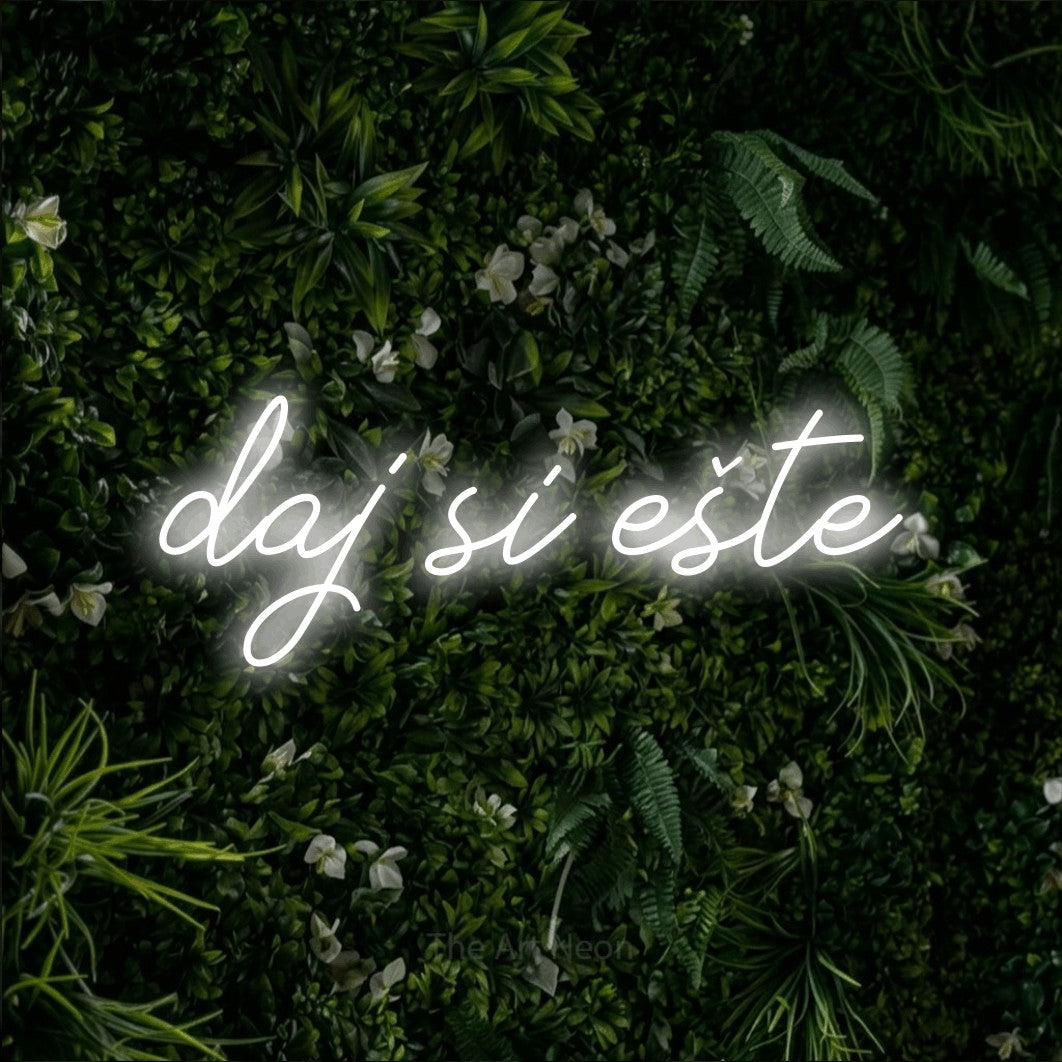 LED neon sign reading “daj si ešte”, arranged in a single line.