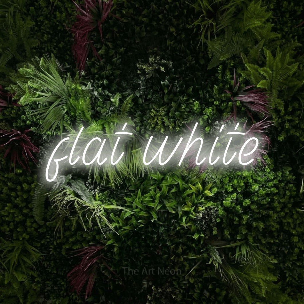 LED neon sign reading “flat white”, arranged in a single line.