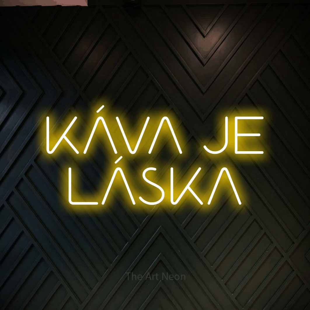 LED neon sign reading “KÁVA JE LÁSKA”, arranged in two lines.