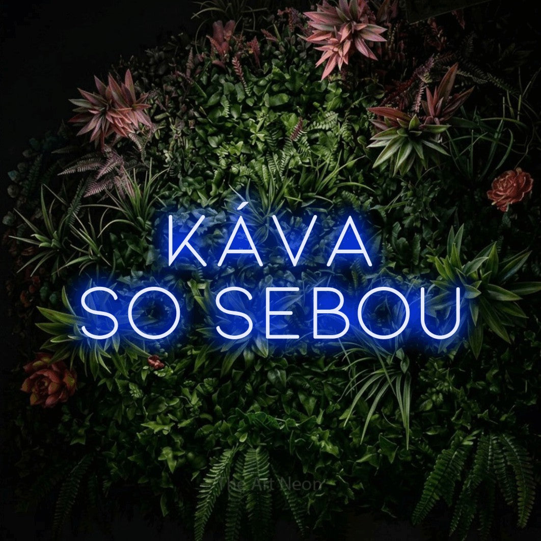 LED neon sign reading “KÁVA SO SEBOU”, arranged in two lines.