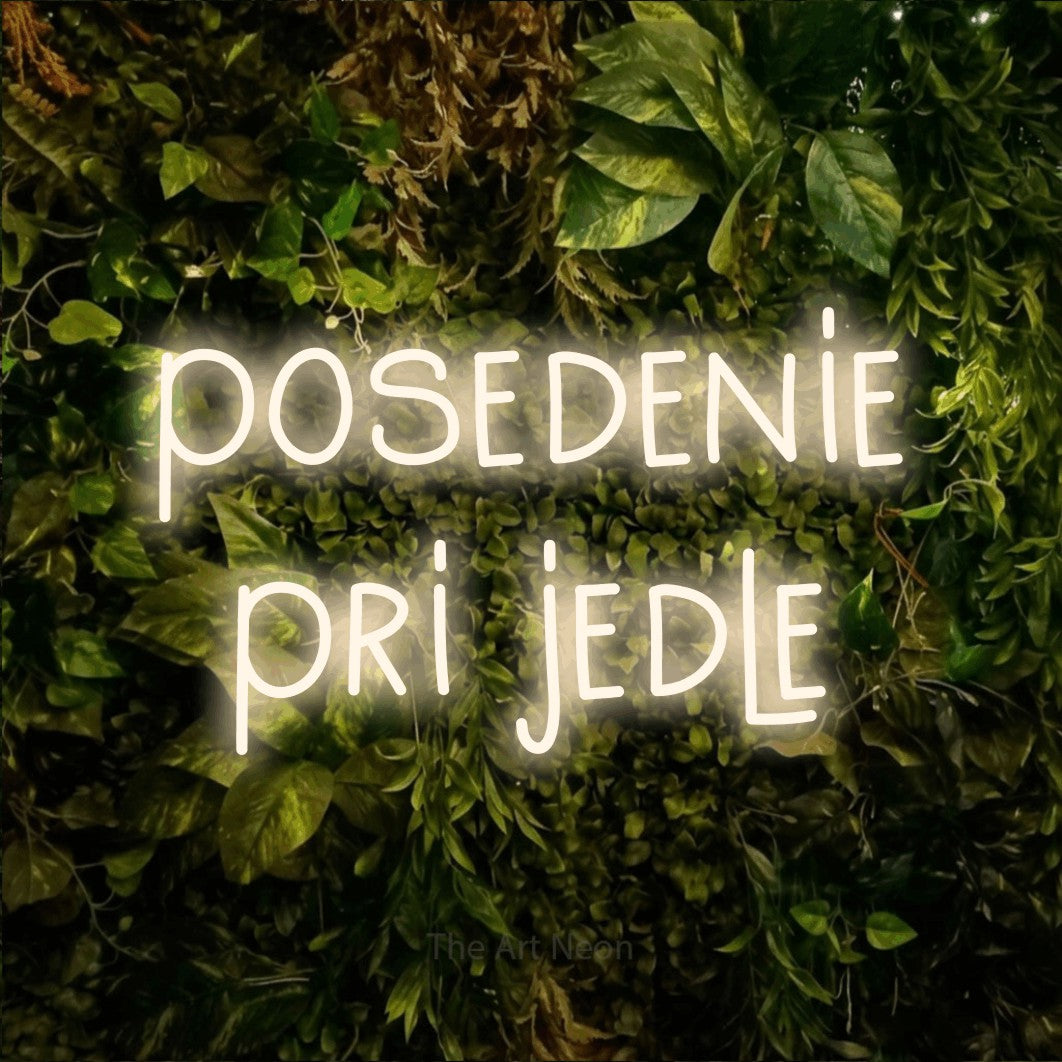 LED neon sign reading “posedenie pri jedle”, arranged in two lines.