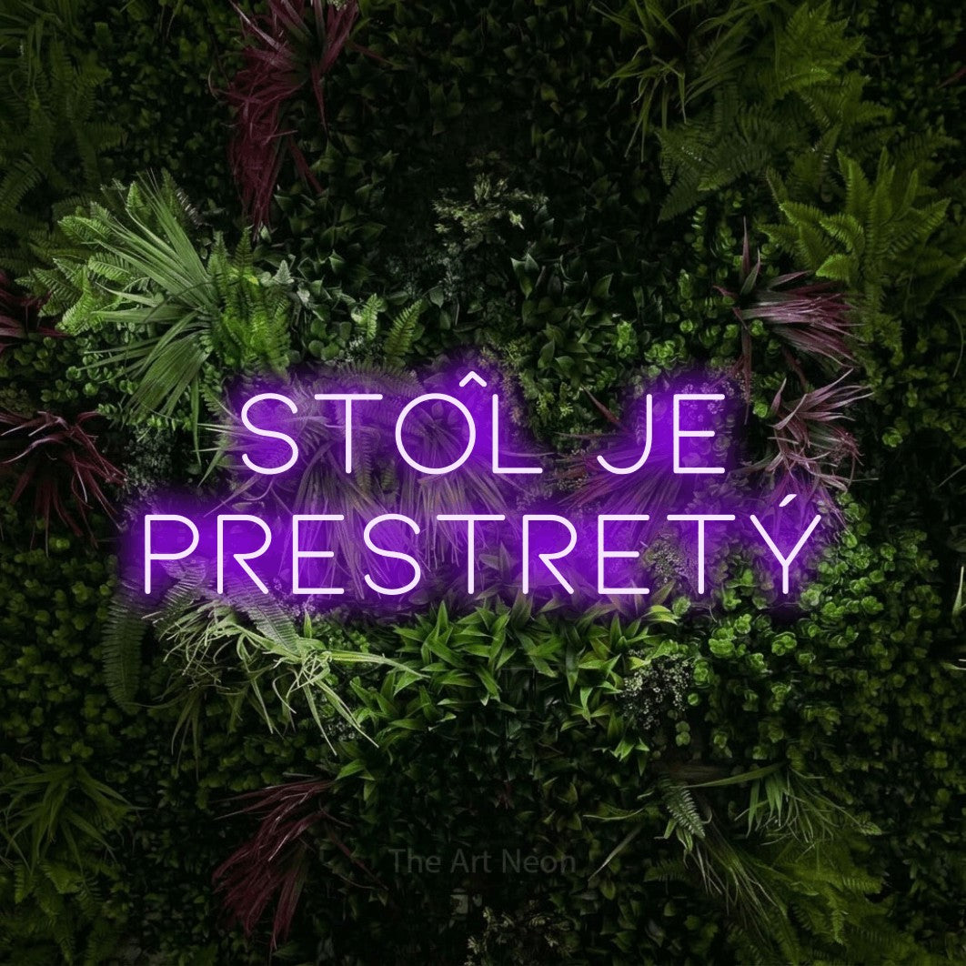 LED neon sign reading “stôl je prestretý”, arranged in two lines.