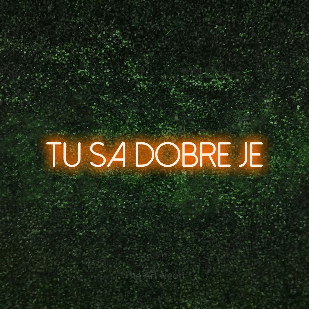 LED neon sign reading “Tu sa Dobre Je”, arranged in a single line.