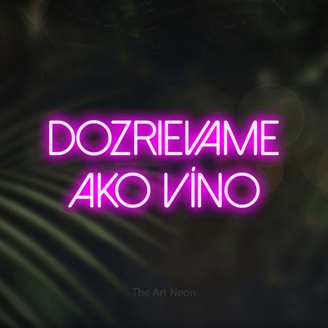 LED neon sign reading “DOZRIEVAME AKO VÍNO”, arranged in two lines.