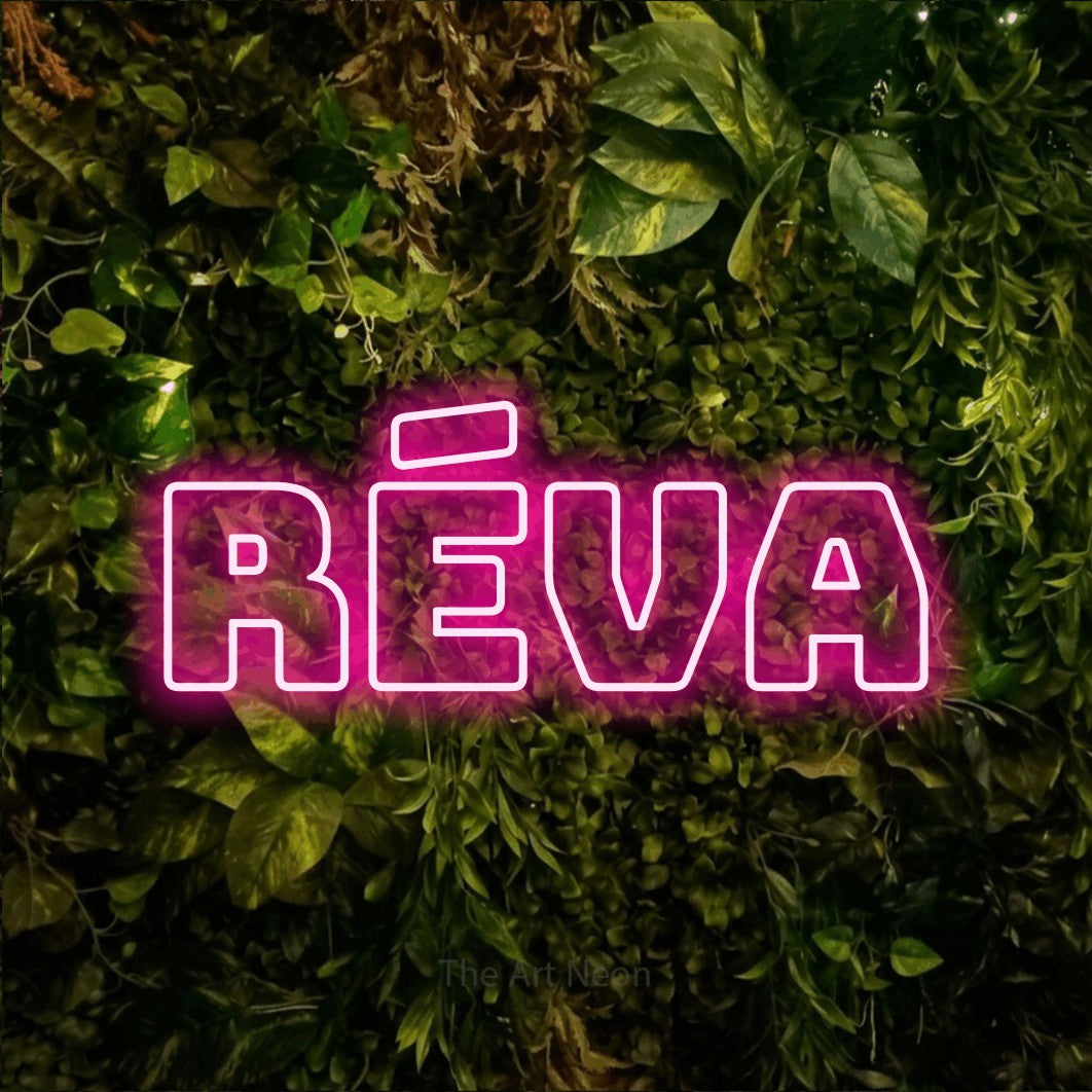 LED neon sign reading “réva”, arranged in a single line.