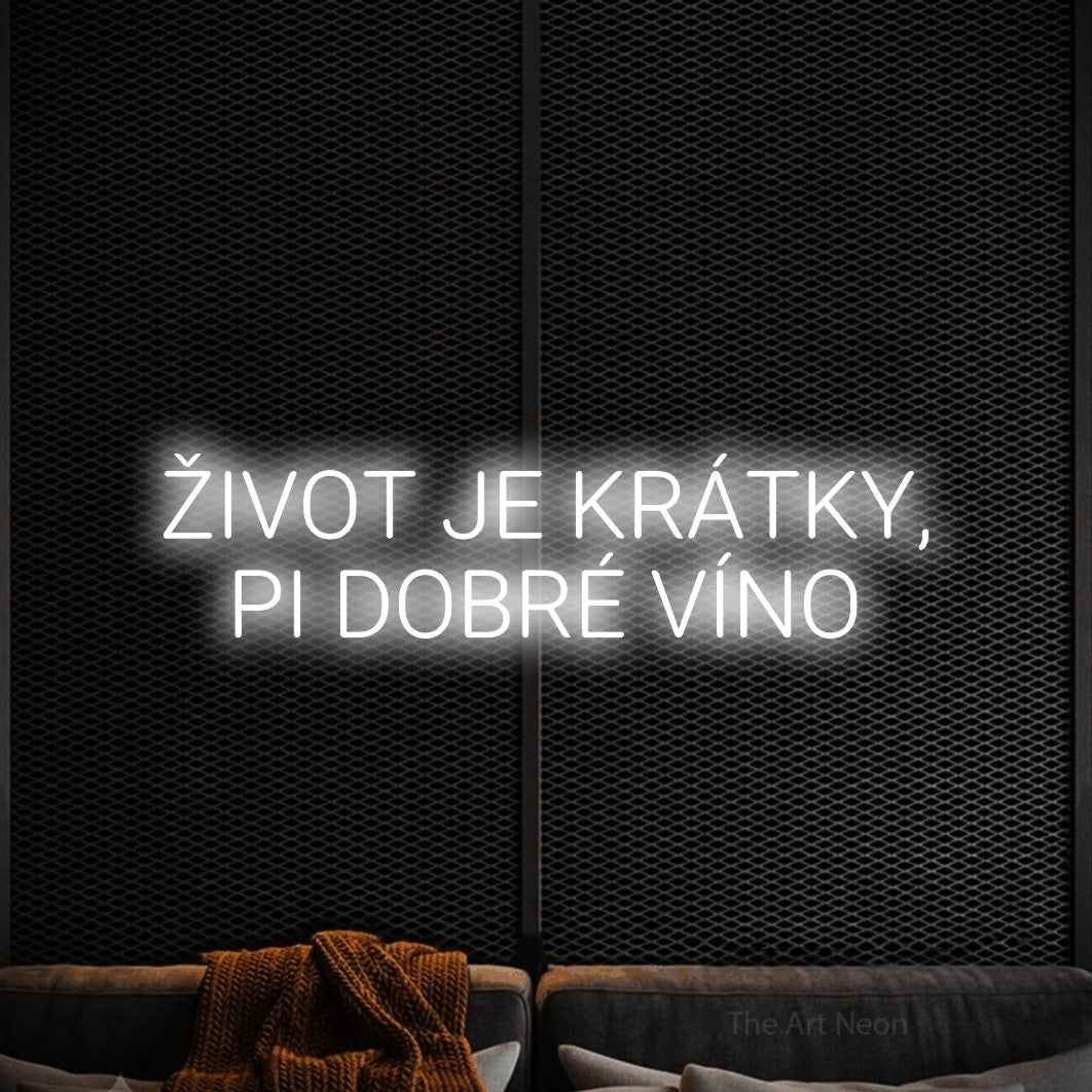 LED neon sign reading “ŽIVOT JE KRÁTKY, PI DOBRÉ VÍNO”, arranged in two lines.