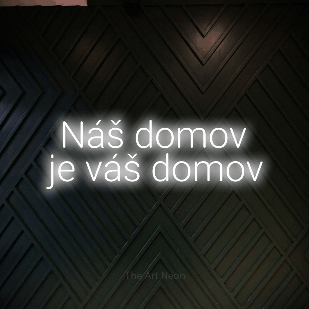 LED neon sign reading “Náš domov je váš domov”, arranged in two lines.