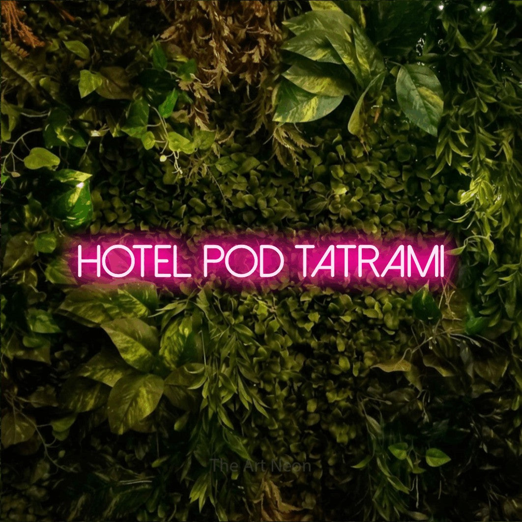 LED neon sign reading “hotel pod TATRAMI”, arranged in a single line.