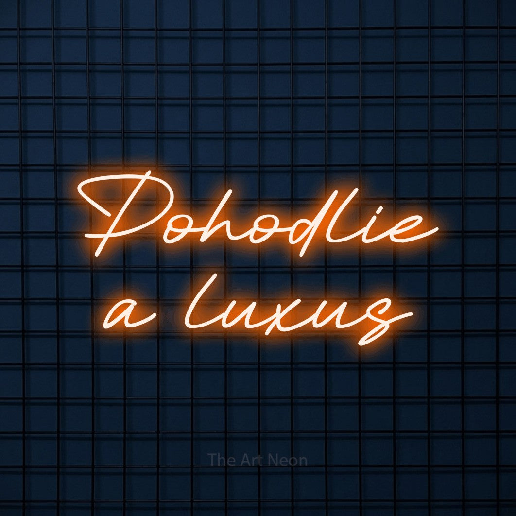 LED neon sign reading “Pohodlie a luxus”, arranged in two lines.