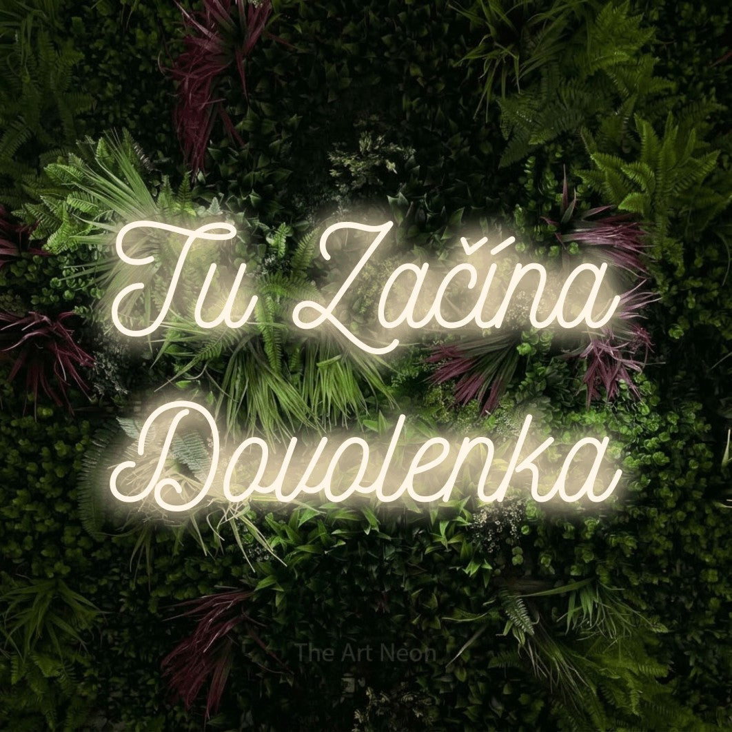 LED neon sign reading “Tu Začína Dovolenka”, arranged in two lines.
