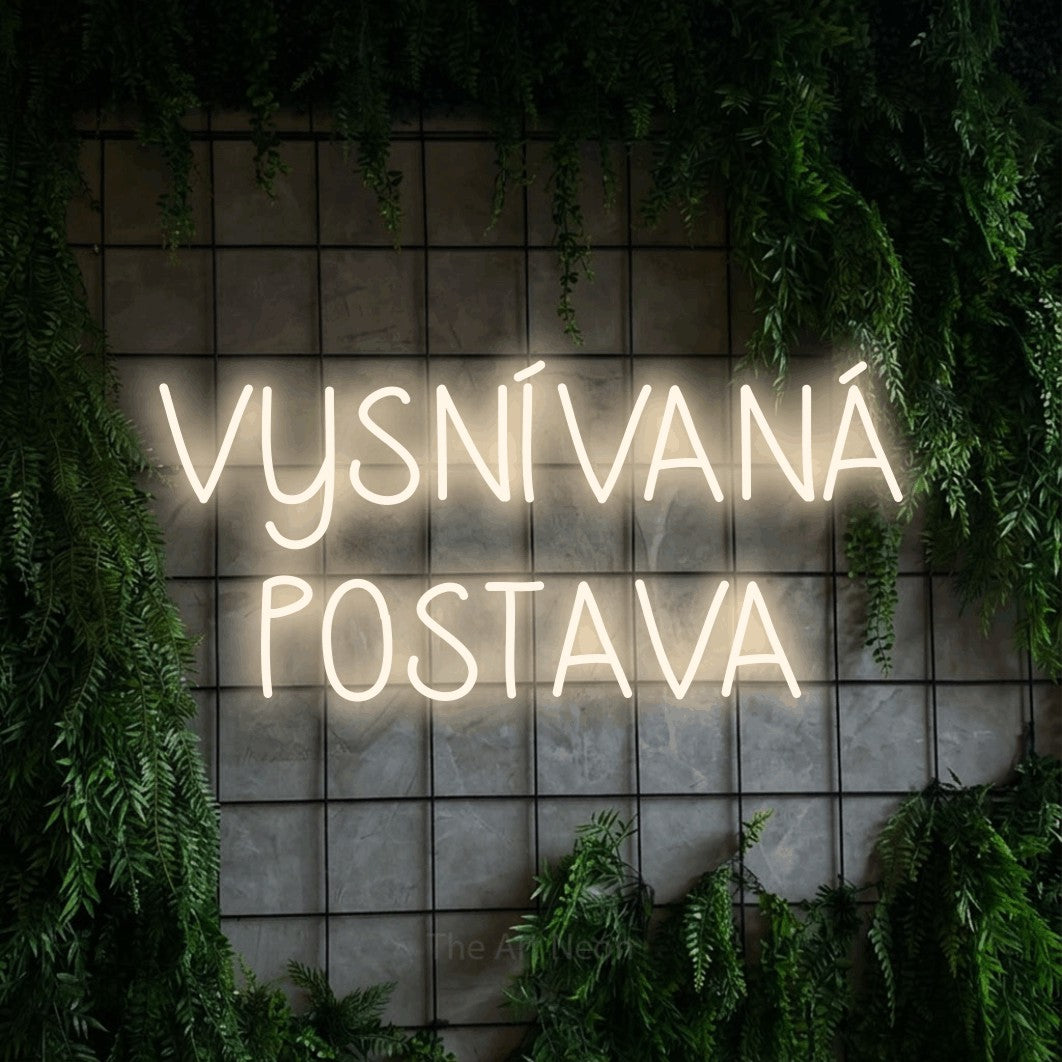 LED neon sign reading “VYSNÍVANÁ POSTAVA”, arranged in two lines.