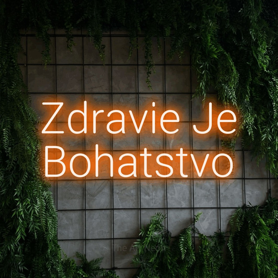 LED neon sign reading “Zdravie Je Bohatstvo”, arranged in two lines.