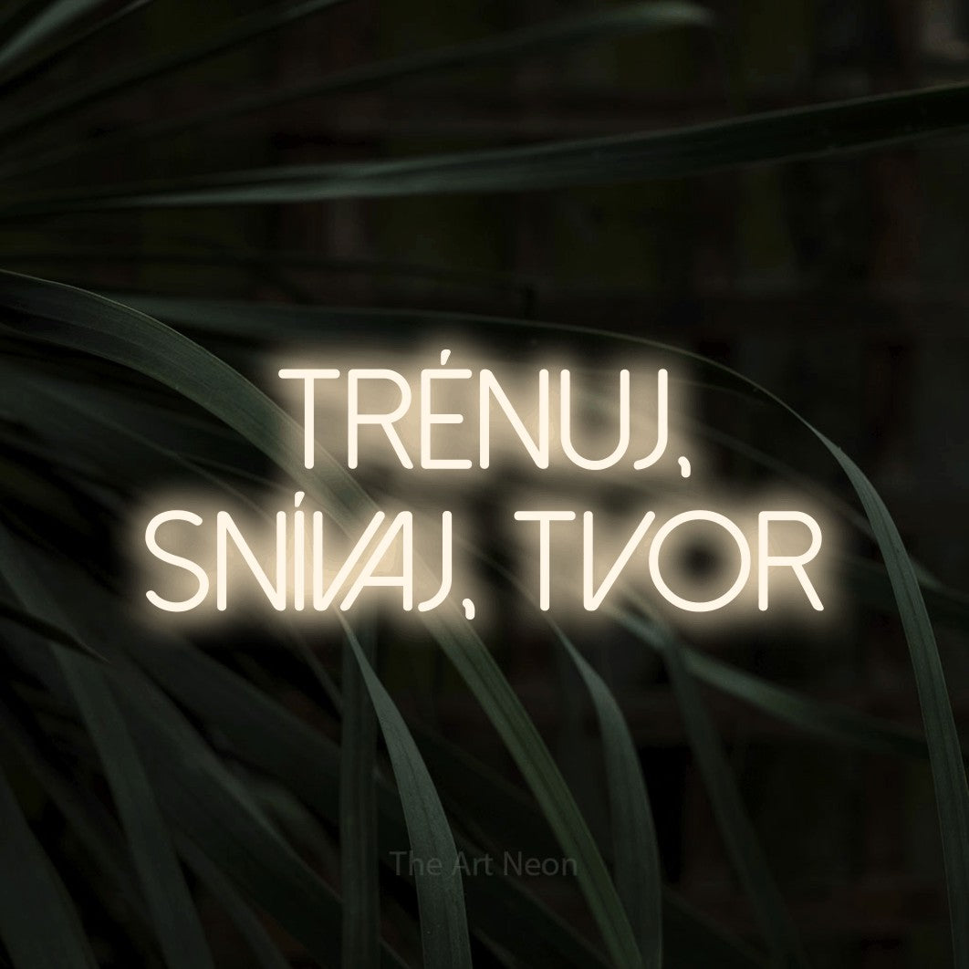 LED neon sign reading “Trénuj, snívaj, tvor”, arranged in two lines.