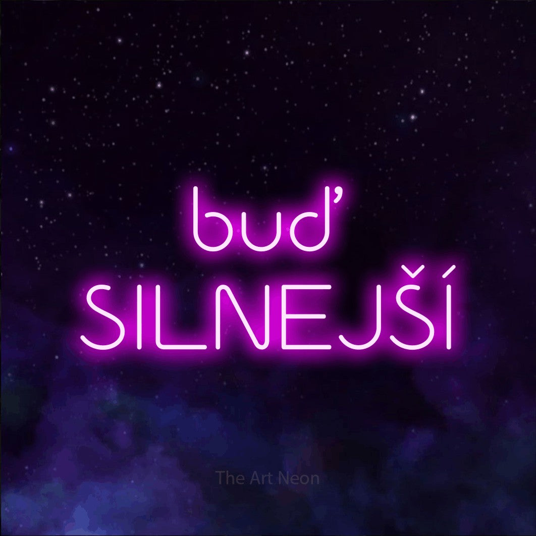 LED neon sign reading “buď SILNEJŠÍ”, arranged in two lines.