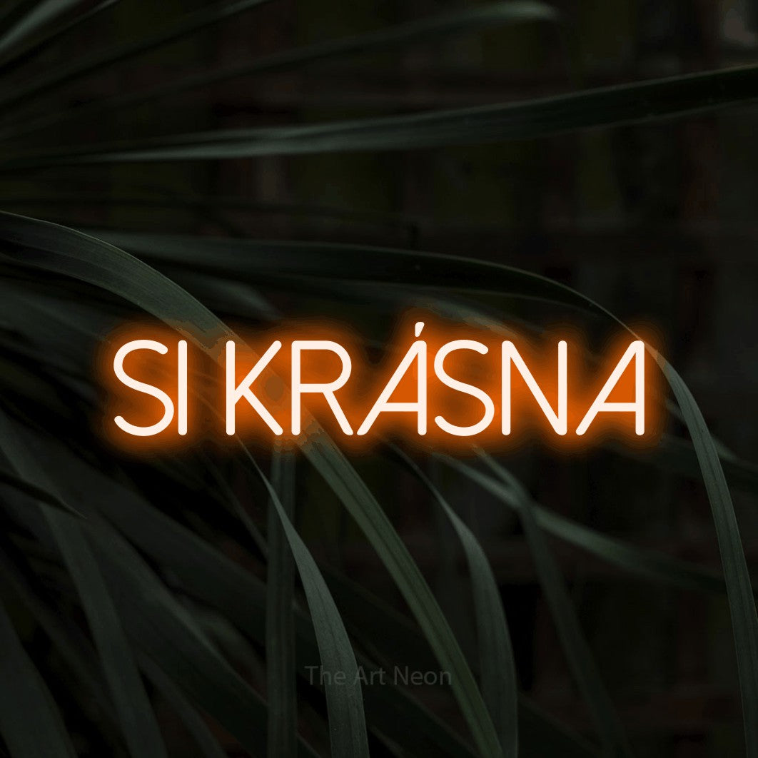 LED neon sign reading “SI KRÁSNA”, arranged in a single line.