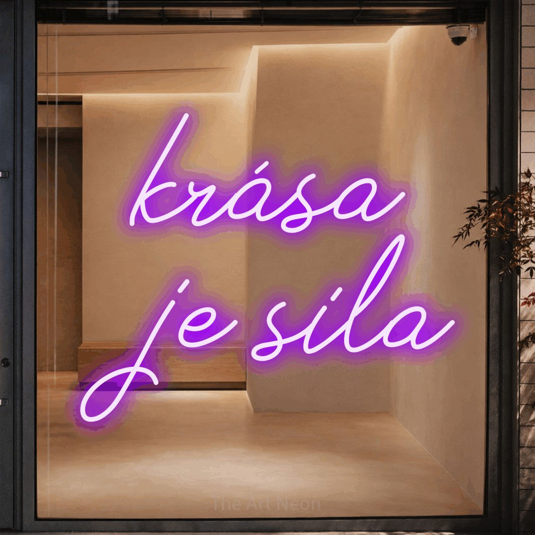 LED neon sign reading “krása je sila”, arranged in two lines.