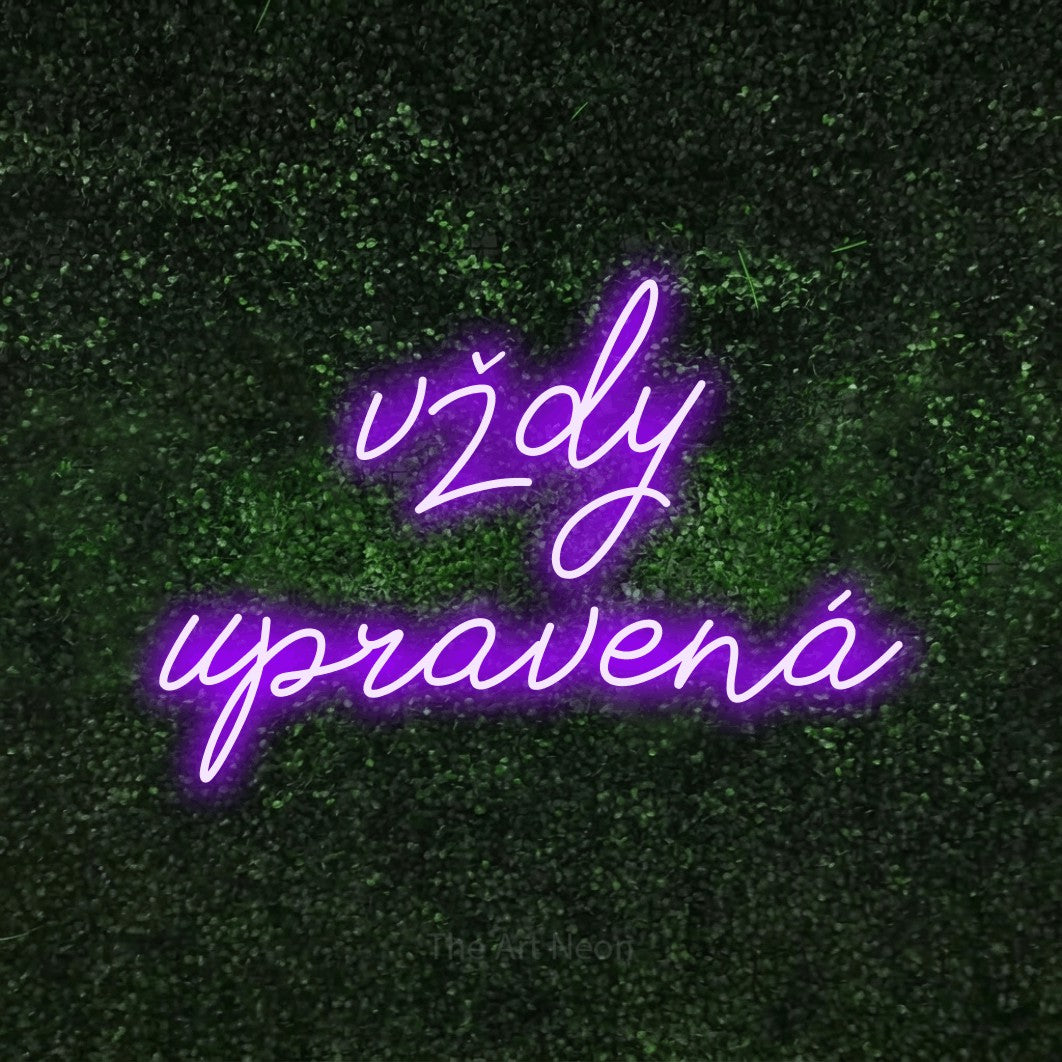 LED neon sign reading “vždy upravená”, arranged in two lines.