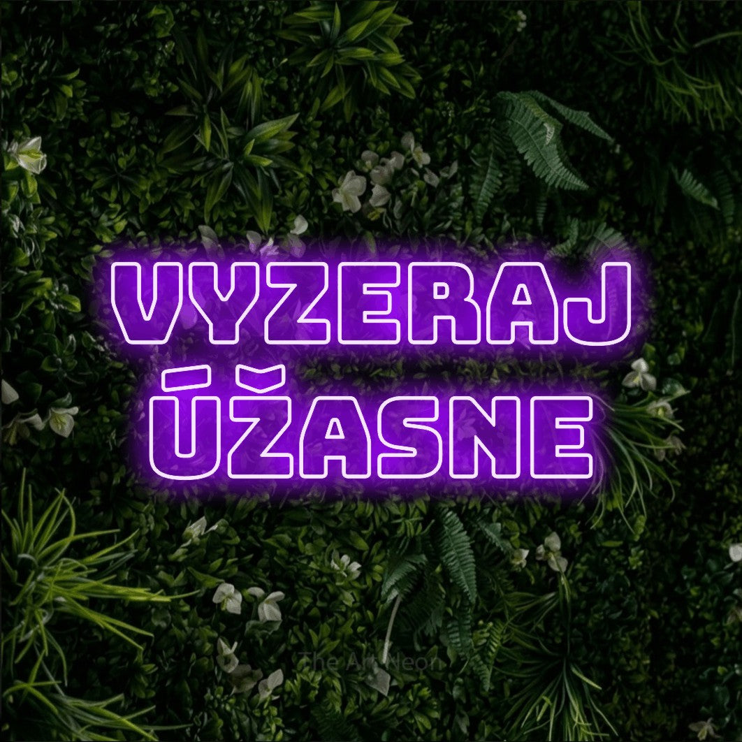 LED neon sign reading “VYZERAJ úžasne”, arranged in two lines.