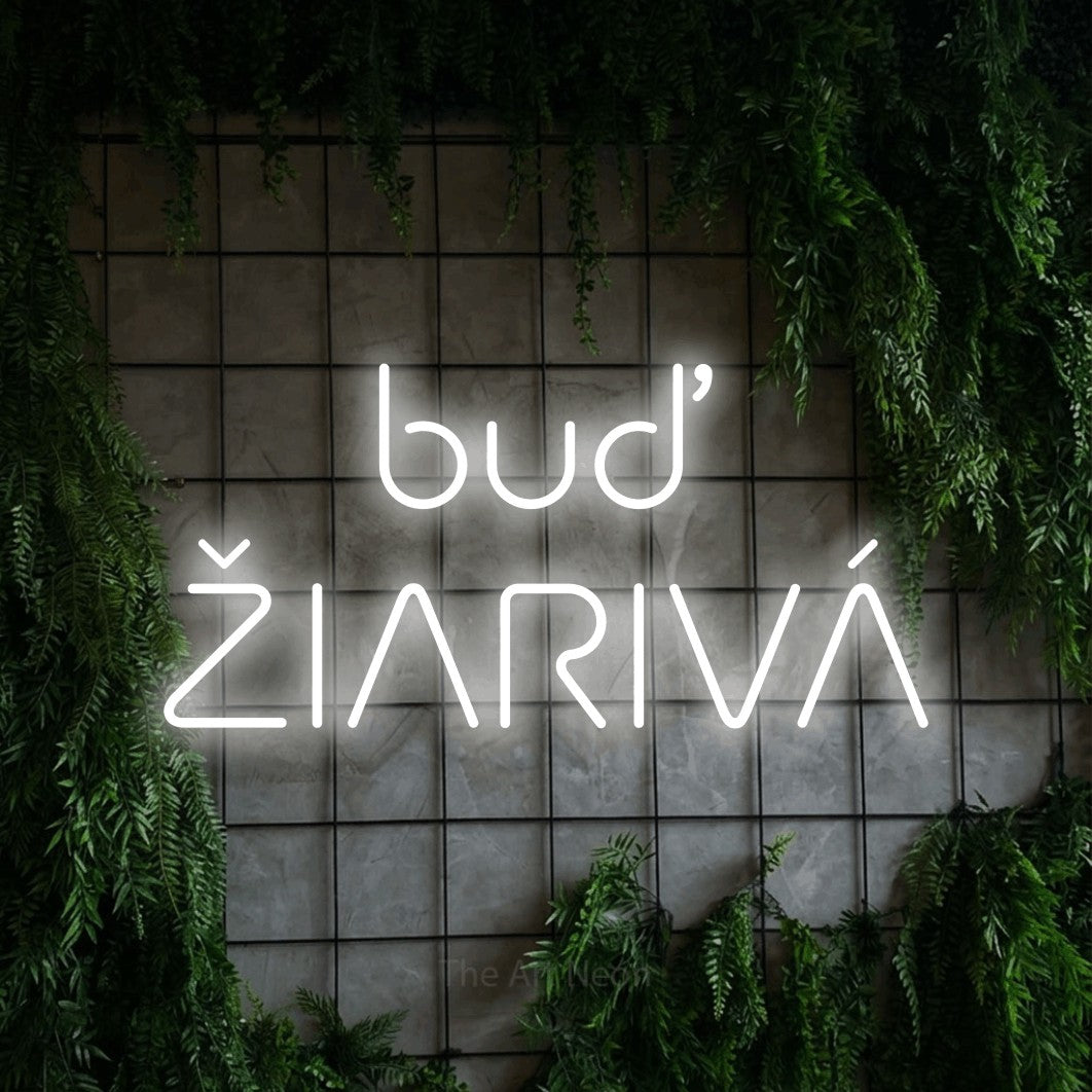 LED neon sign reading “buď ŽIARIVÁ”, arranged in two lines.