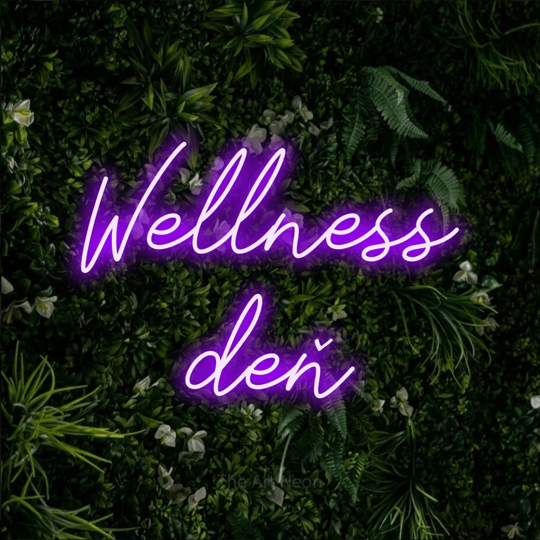 LED neon sign reading “Wellness deň”, arranged in two lines.