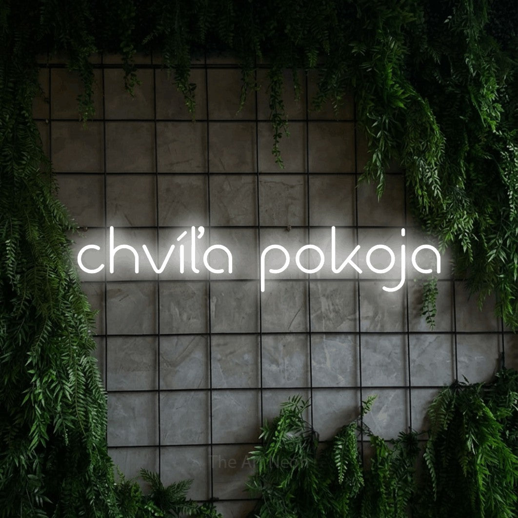 LED neon sign reading “chvíľa pokoja”, arranged in a single line.