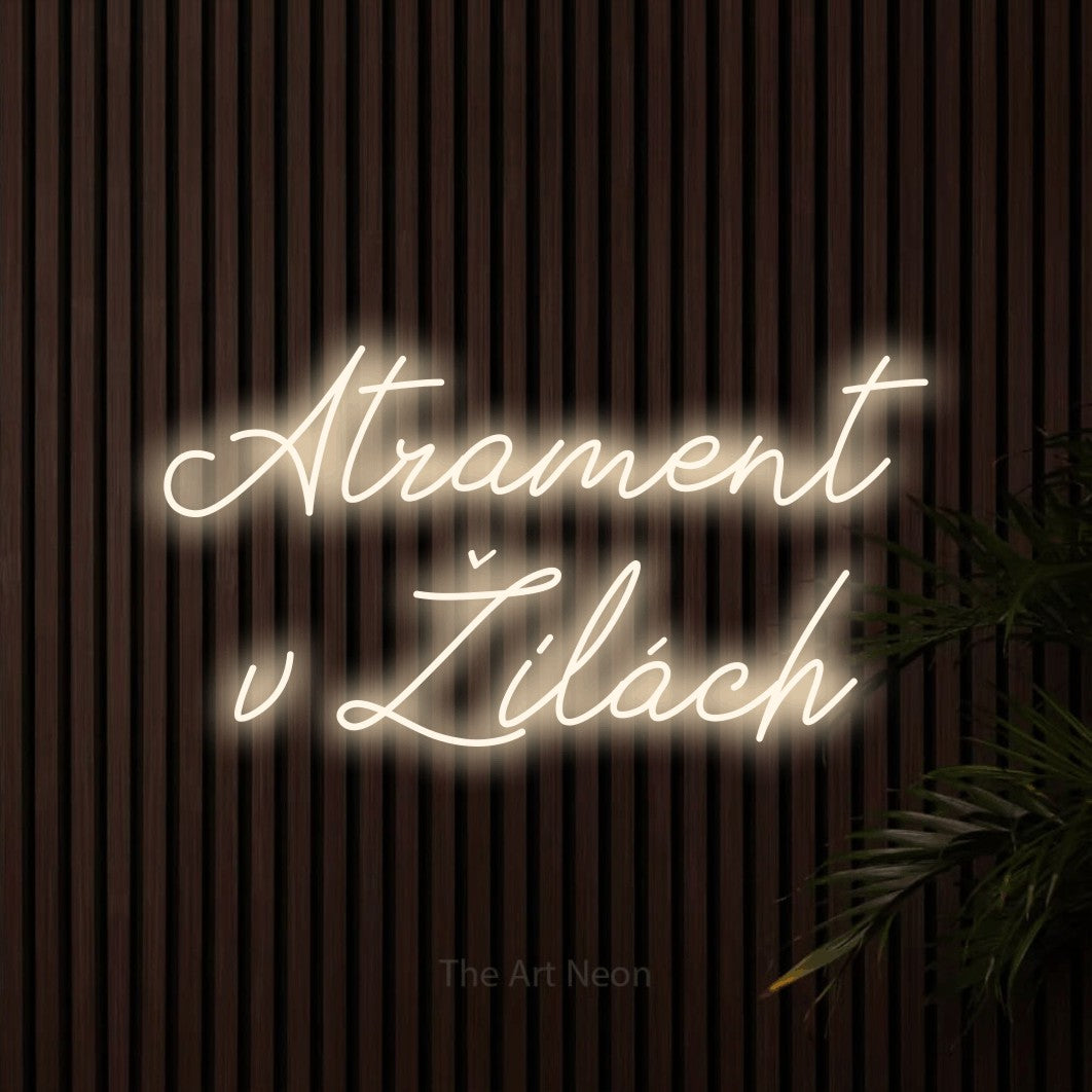 LED neon sign reading “Atrament v Žilách”, arranged in two lines.