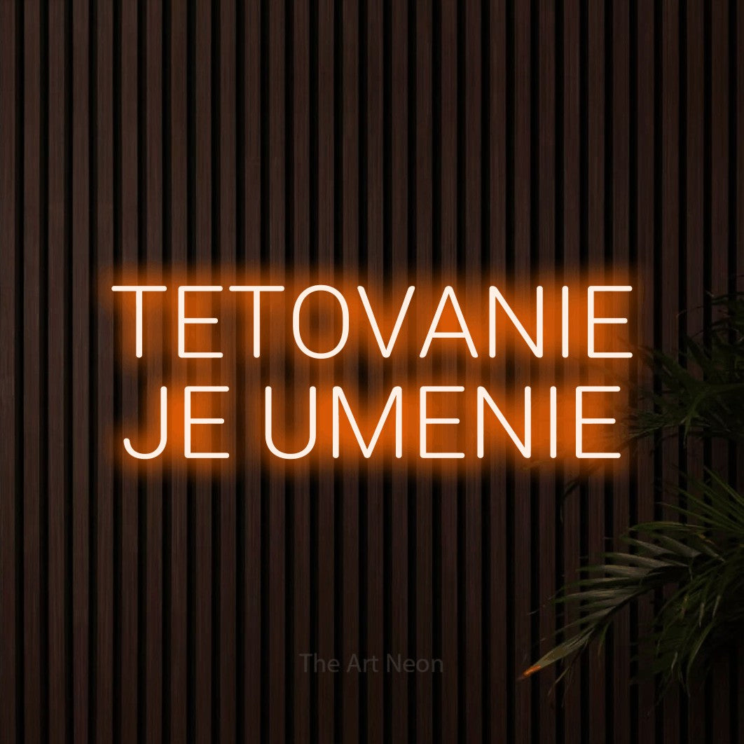 LED neon sign reading “TETOVANIE JE UMENIE”, arranged in two lines.