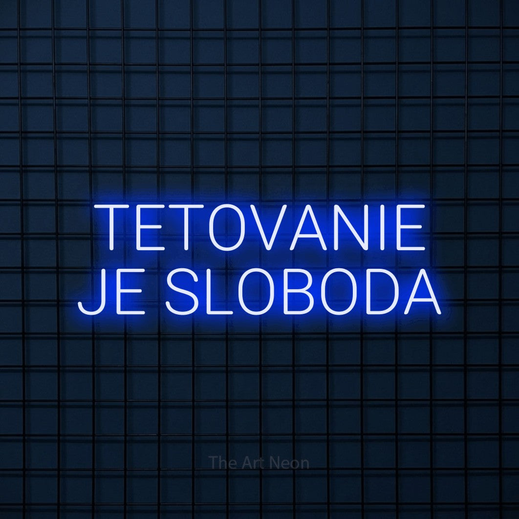 LED neon sign reading “TETOVANIE JE SLOBODA”, arranged in two lines.