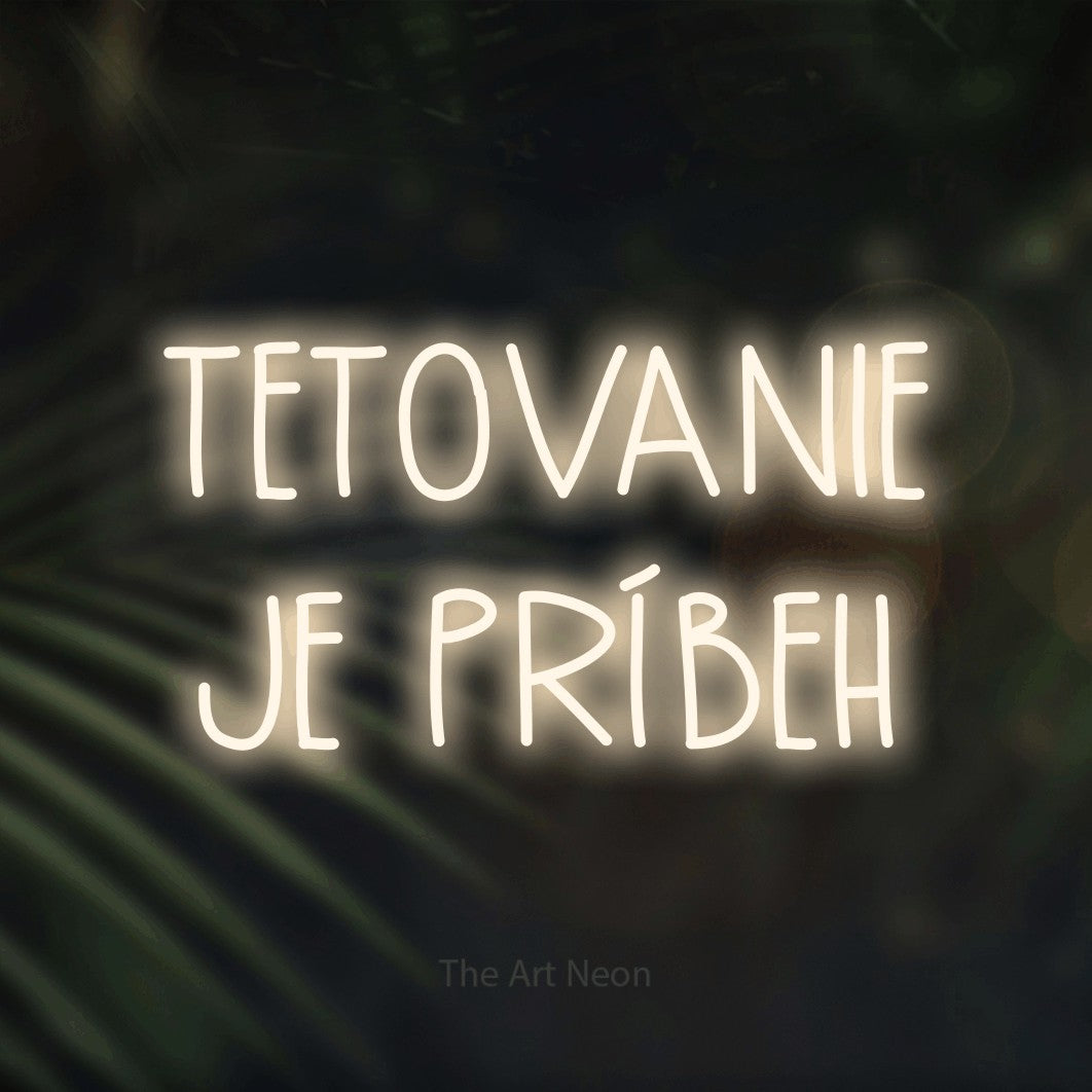 LED neon sign reading “TETOVANIE JE PRÍBEH”, arranged in two lines.