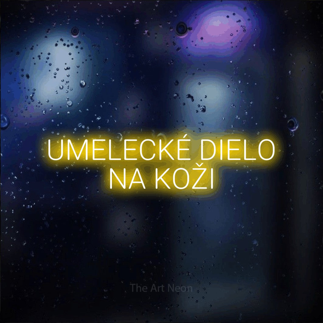 LED neon sign reading “UMELECKÉ DIELO NA KOŽI”, arranged in two lines.