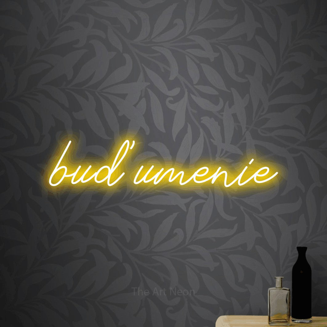 LED neon sign reading “buď umenie”, arranged in a single line.