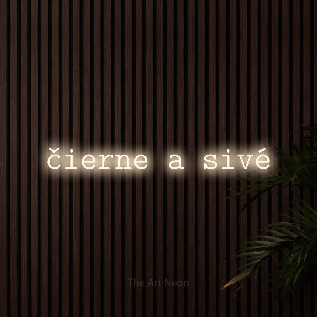 LED neon sign reading “čierne a sivé”, arranged in a single line.