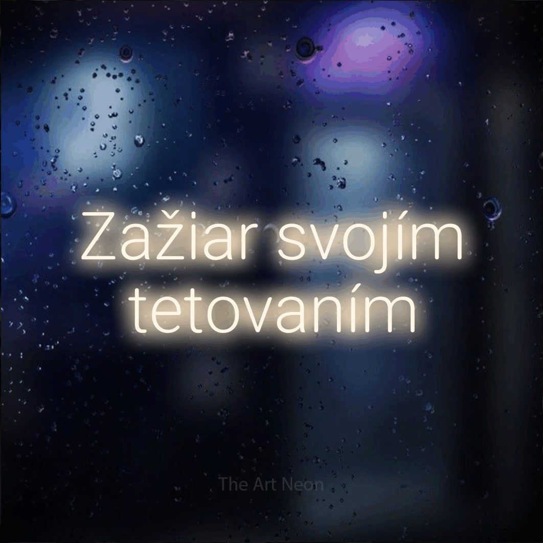 LED neon sign reading “Zažiar svojím tetovaním”, arranged in two lines.