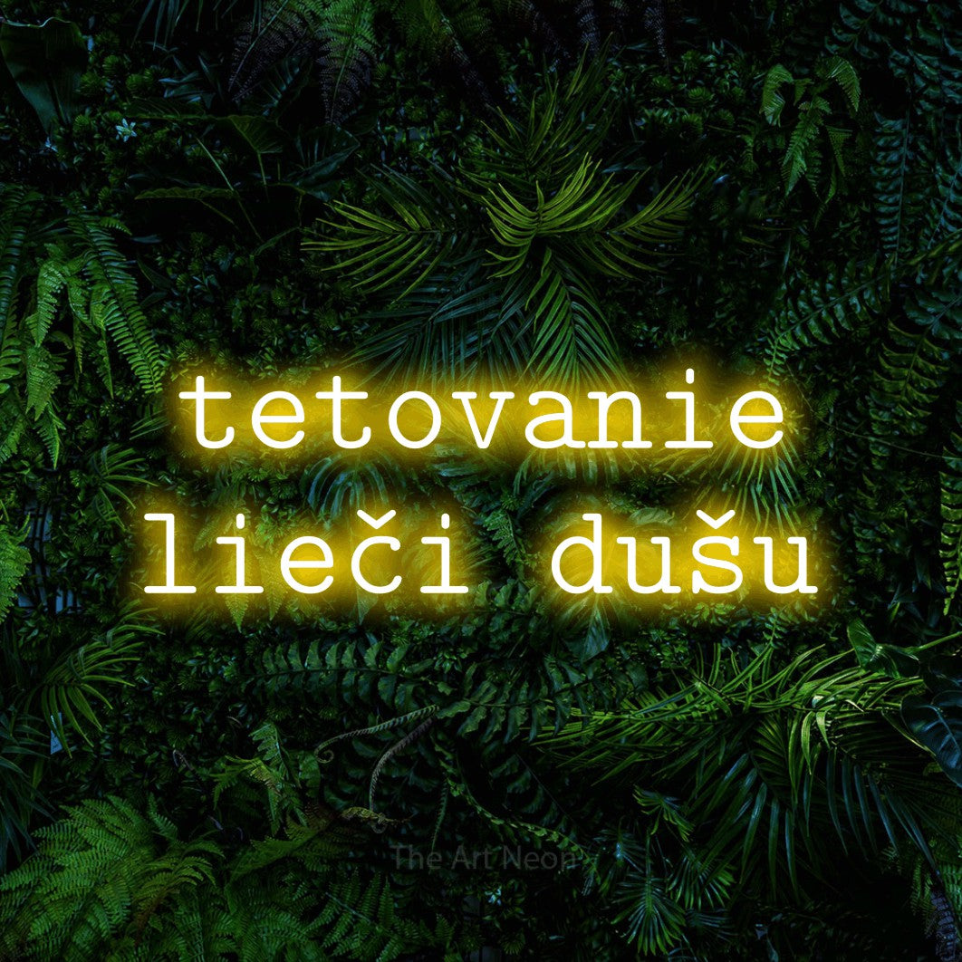 LED neon sign reading “tetovanie lieči dušu”, arranged in two lines.