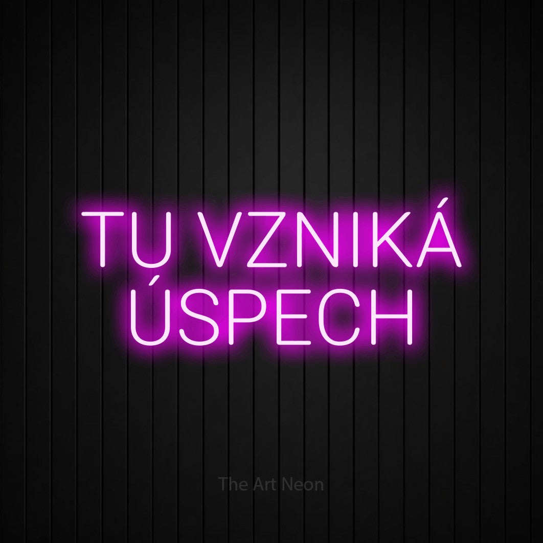 LED neon sign reading “TU VZNIKÁ ÚSPECH”, arranged in two lines.