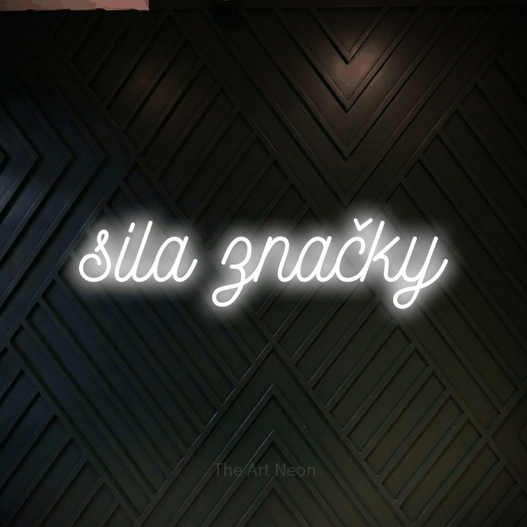 LED neon sign reading “sila značky”, arranged in a single line.