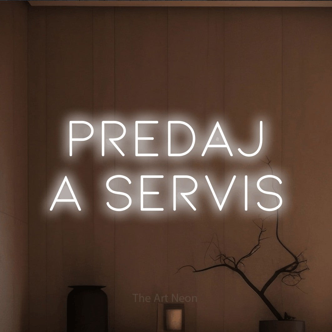 LED neon sign reading “PREDAJ A SERVIS”, arranged in two lines.