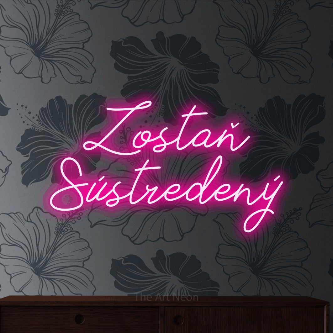 LED neon sign reading “Zostaň Sústredený”, arranged in two lines.