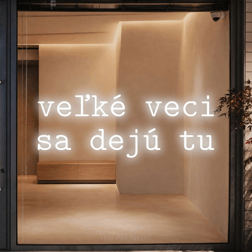 LED neon sign reading “veľké veci sa dejú tu”, arranged in two lines.