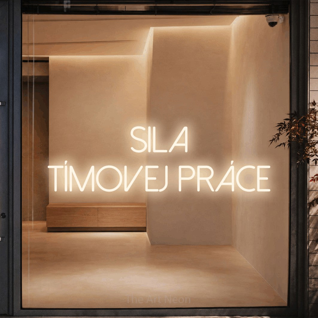 LED neon sign reading “Sila Tímovej Práce”, arranged in two lines.