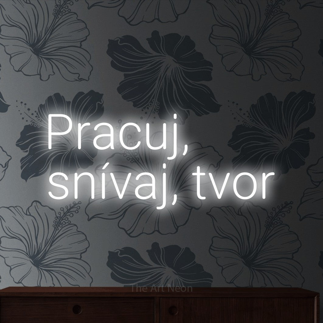 LED neon sign reading “Pracuj, snívaj, tvor”, arranged in two lines.