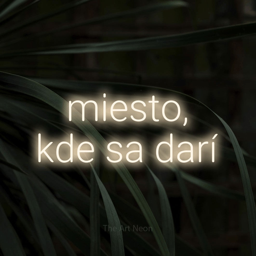 LED neon sign reading “miesto, kde sa darí”, arranged in two lines.